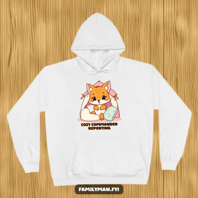 Funny fox cub hoodie, a cute animal masterfully building a pillow fort, emphasizing warmth and playful creativity.